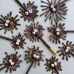 Chocolate pretzel firework treats with candy eyes and sprinkle decorations.