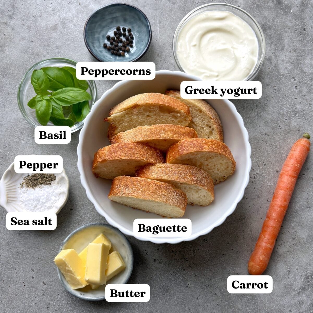 Sliced baguette, Greek yogurt, carrot, butter, sea salt, pepper, peppercorns, and fresh basil.