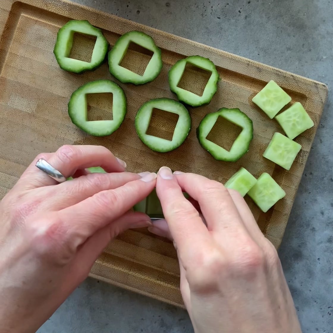 Slices of cucumber being cut out with a square cutter