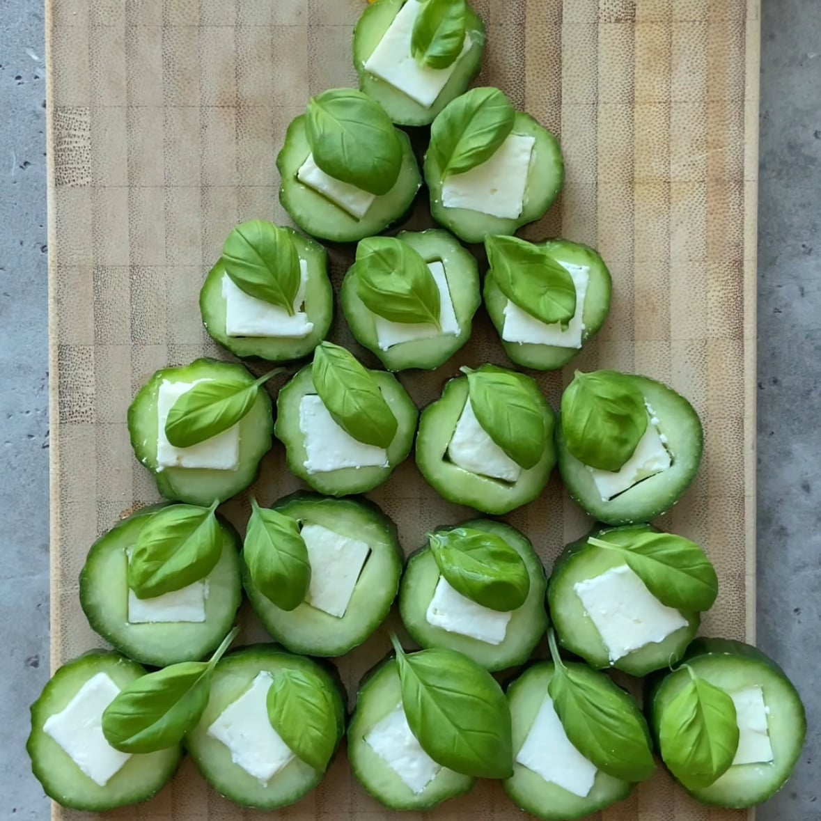Slices of filled cucumber are arranged in the shape of a tree.