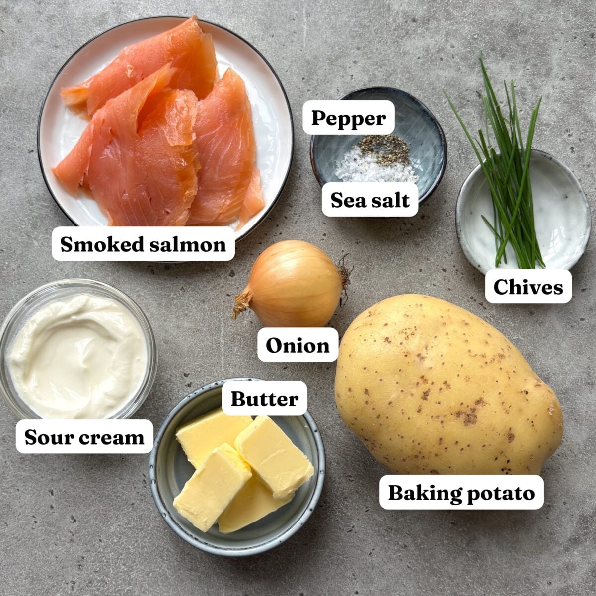 Ingredients including smoked salmon, sour cream, butter, and a baking potato.