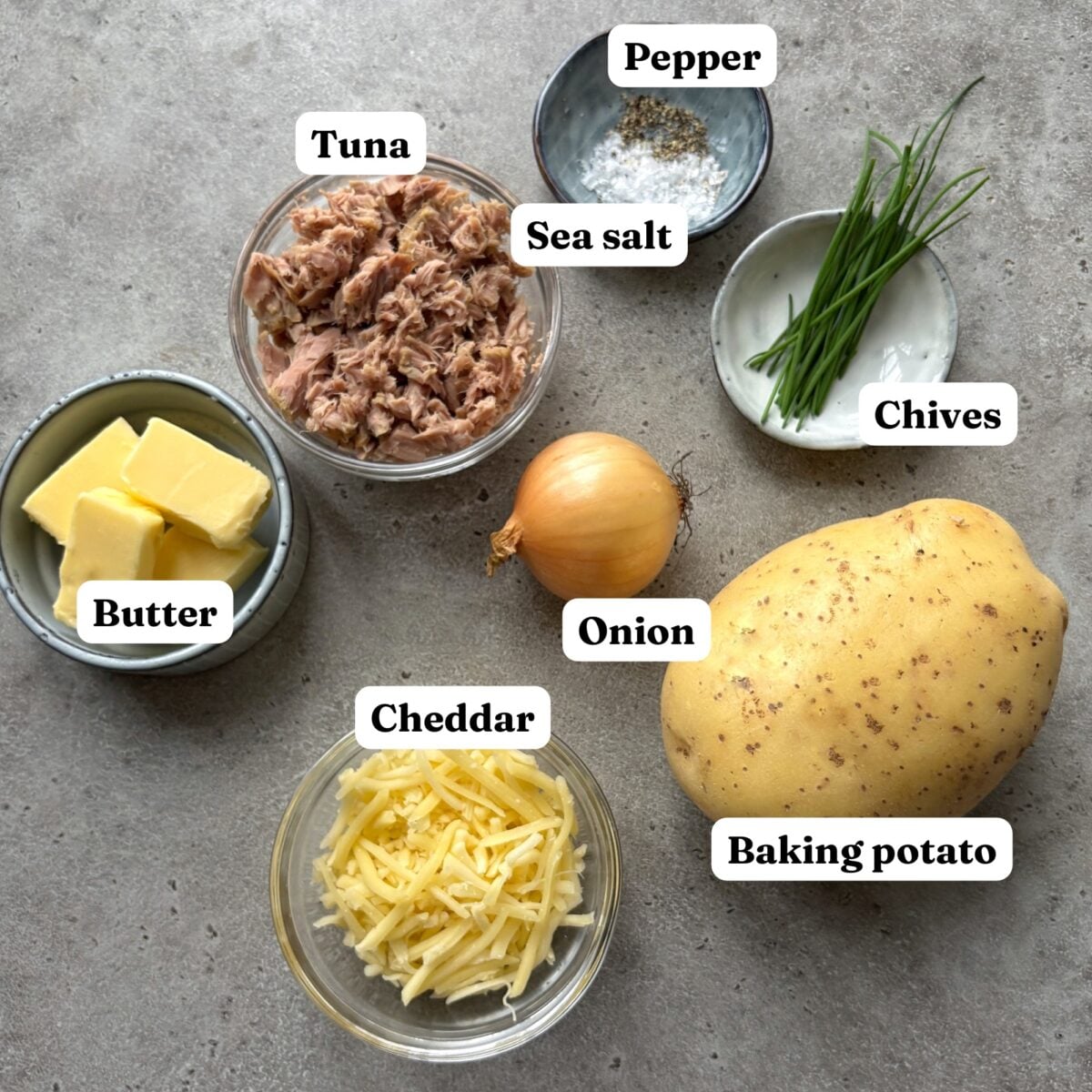 Ingredients including tuna, butter, onion, cheddar, and a baking potato.