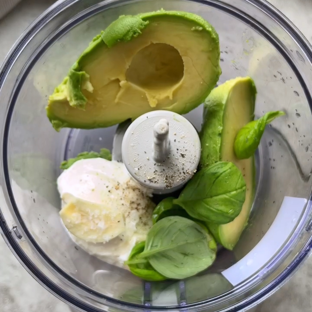 Ingredients needed for the avocado dressing are in a mini processor ready to blend.