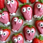 Strawberries dipped in pink icing with candy eyes and fondant noses and feet, these adorable bites make for fun food recipes that look like cute, cartoonish characters.