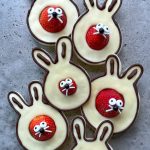 Five bunny-shaped treats made of chocolate with white chocolate filling, each featuring a strawberry for a nose and decorated with candy eyes and white icing for whiskers and teeth—fun, delicious bites perfect for festive food recipes.
