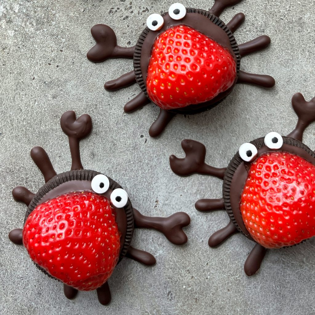 A group of strawberries in the shape of a spider, perfect for creative food recipes or fun party bites.