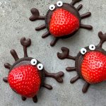 A group of strawberries in the shape of a spider, perfect for creative food recipes or fun party bites.
