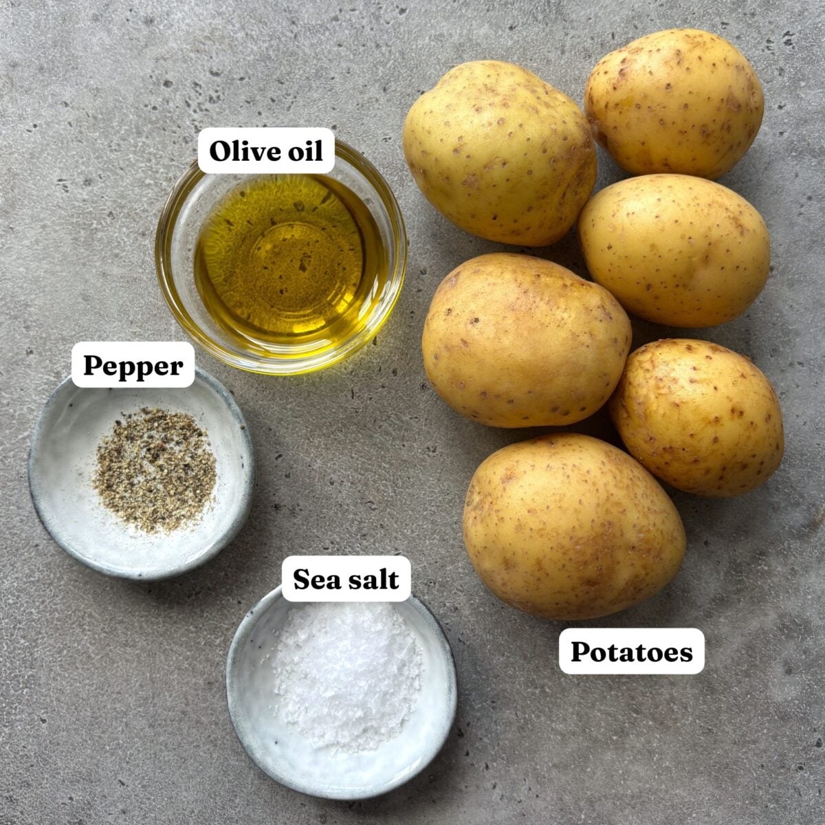 Ingredients for Halloween Fries featuring 6 medium-sized potatoes, a bowl of olive oil, sea salt, and pepper.