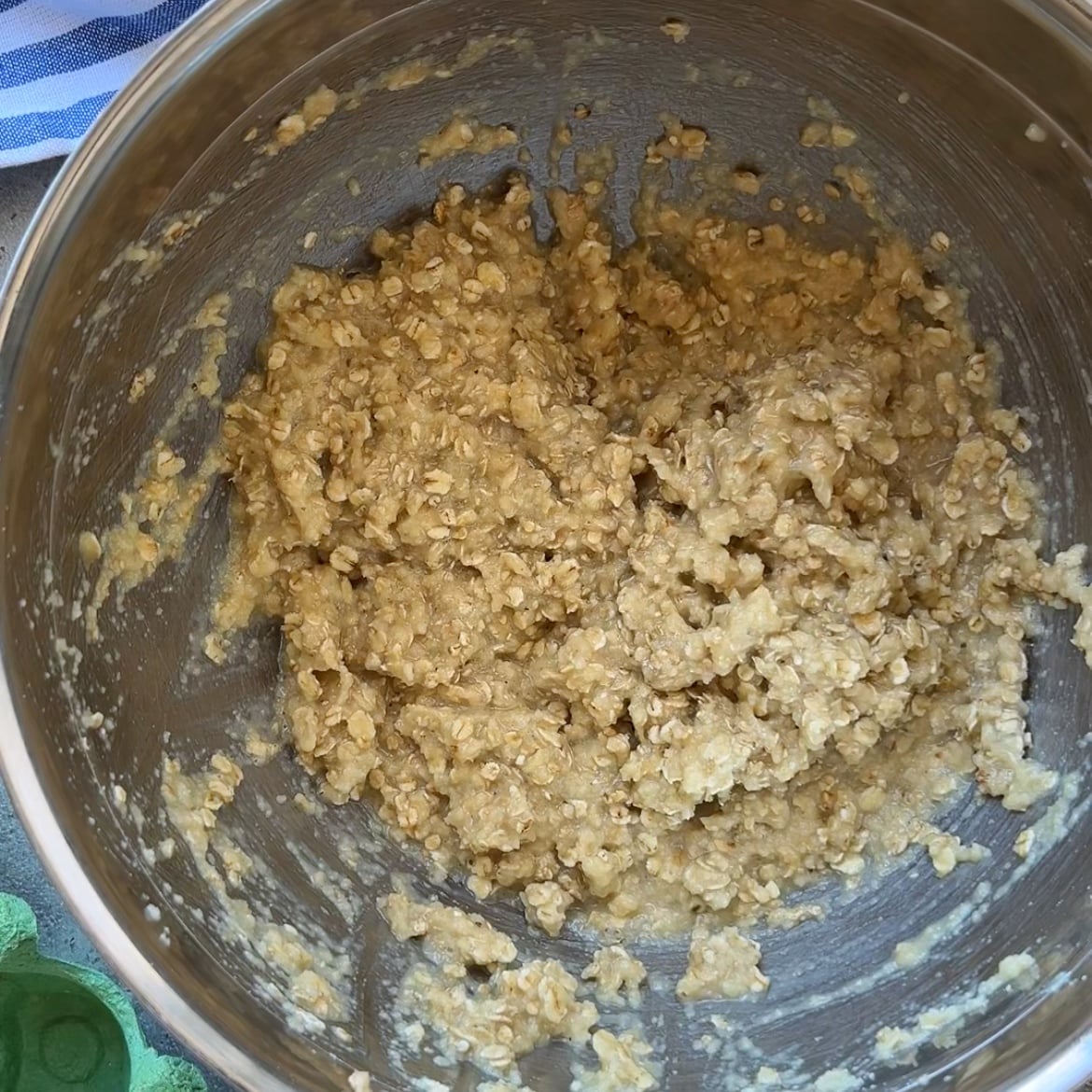 A stainless steel bowl containing a thick, uncooked mixture of batter.