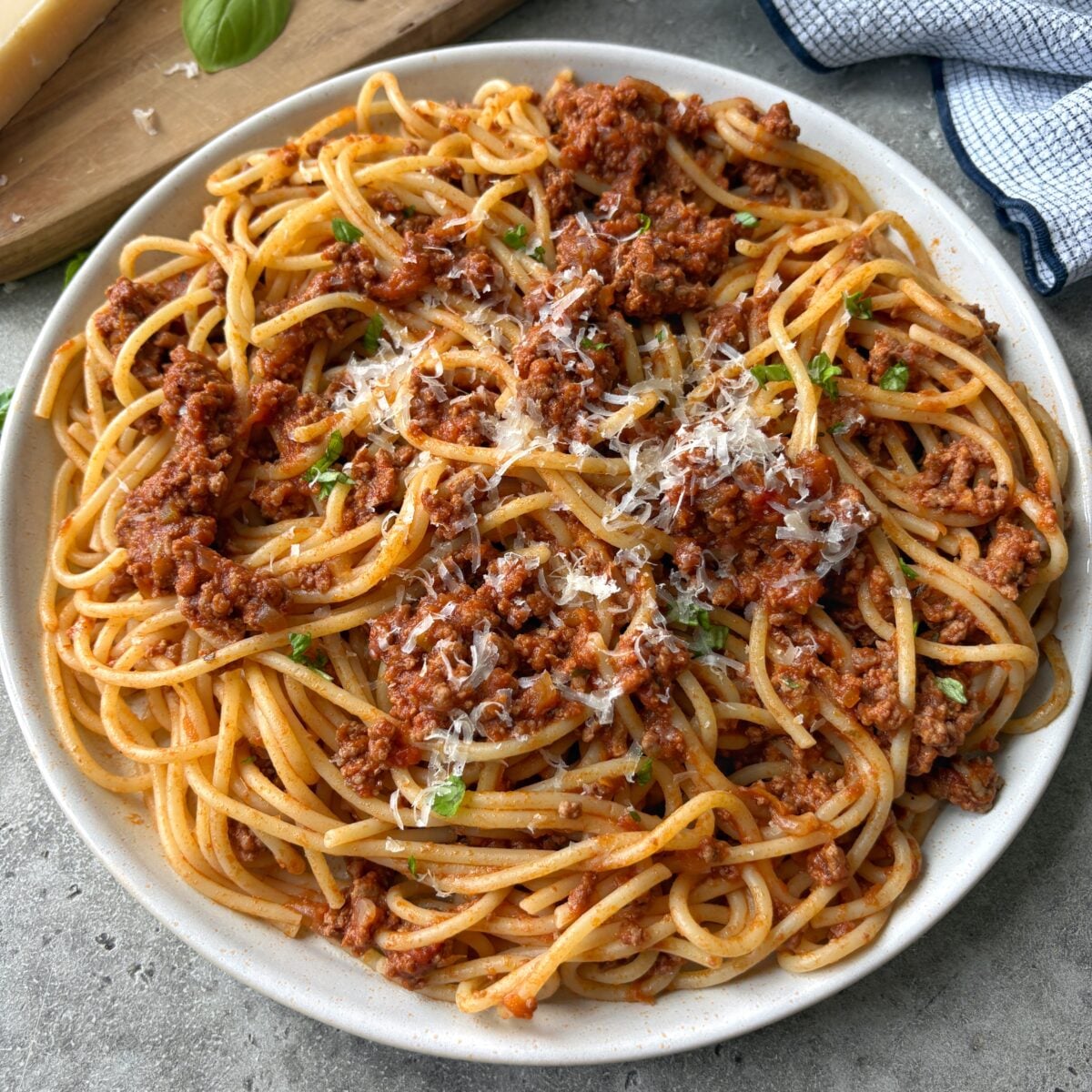 A side view of a plate of beef bolognese. 