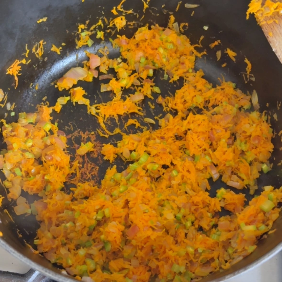 Finely chopped onion, carrots, and celery saut&eacute;ing in a large pot.