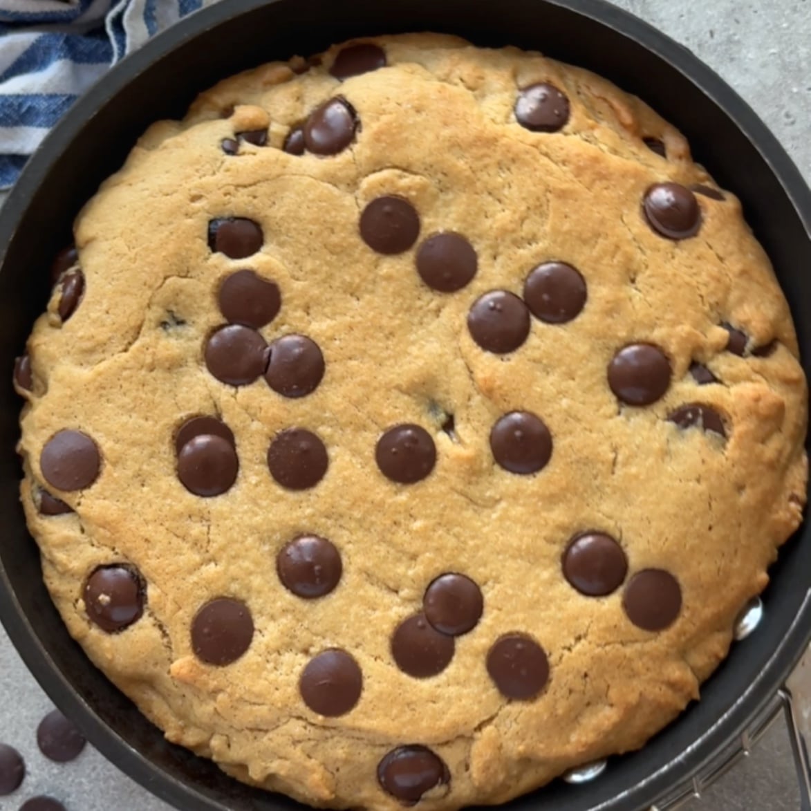A freshly basked chocolate chip cookie skillet with golden brown edges.