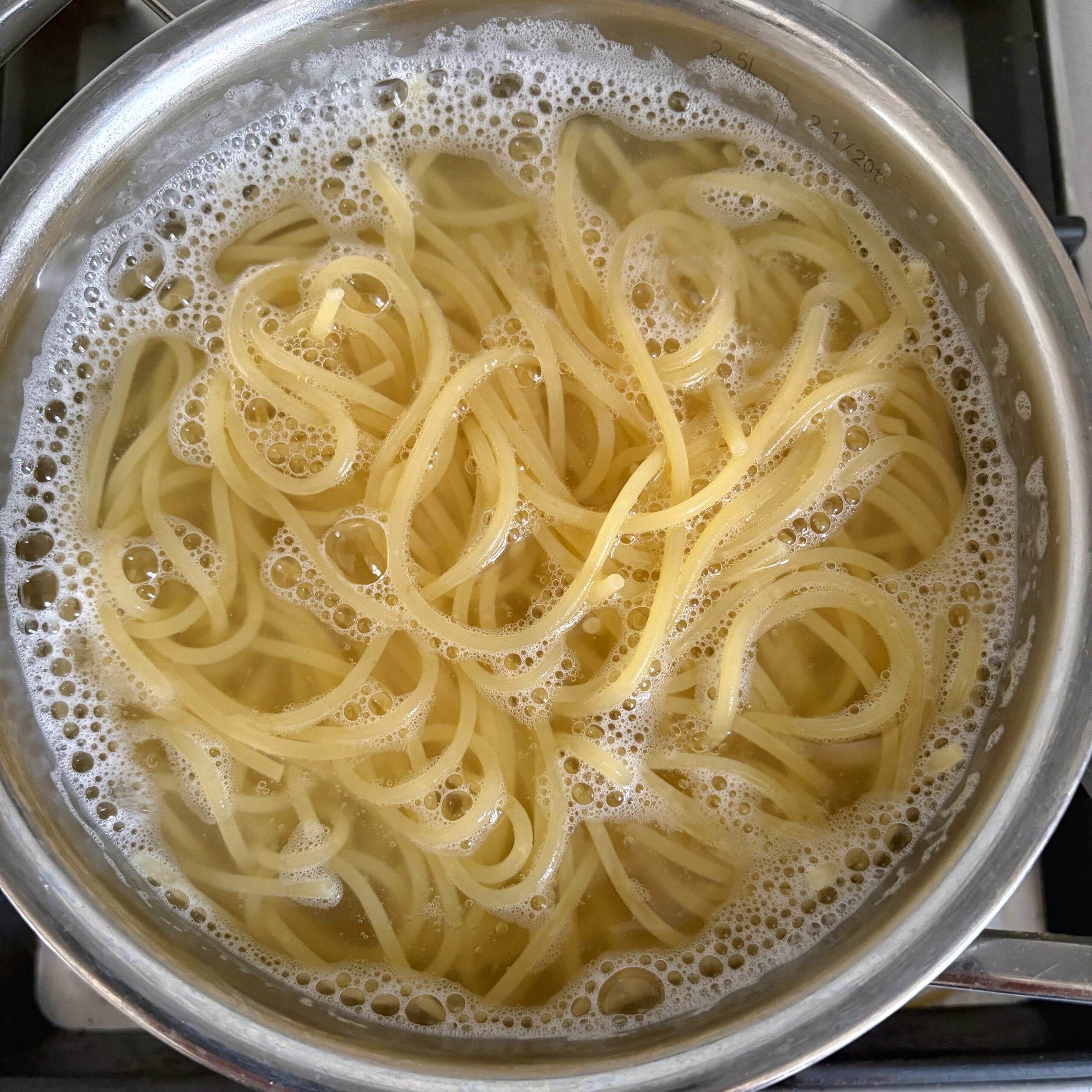 Spaghetti cooking in boiling water.